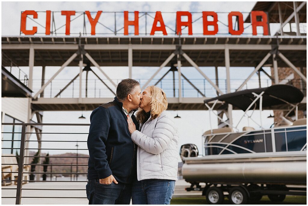 Couple kisses under City Harbor sign