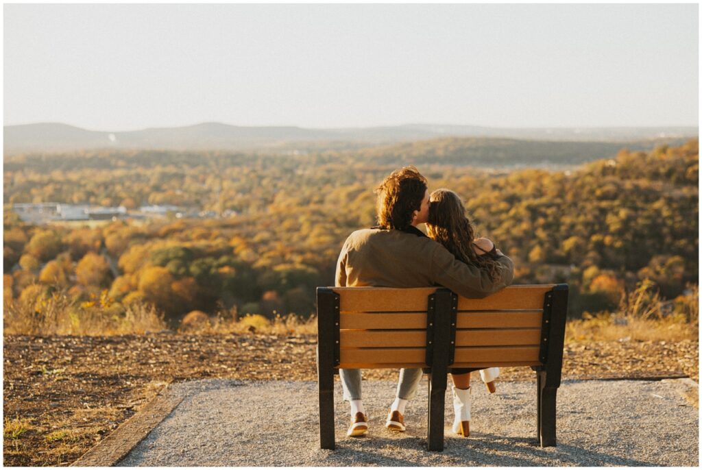 couple sitting on a bench watching the sunset