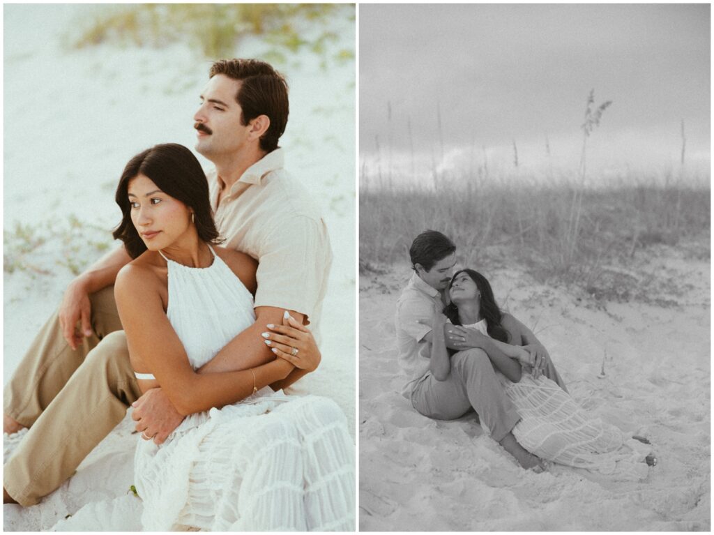 couple sitting on sand dunes at Gulf State Park