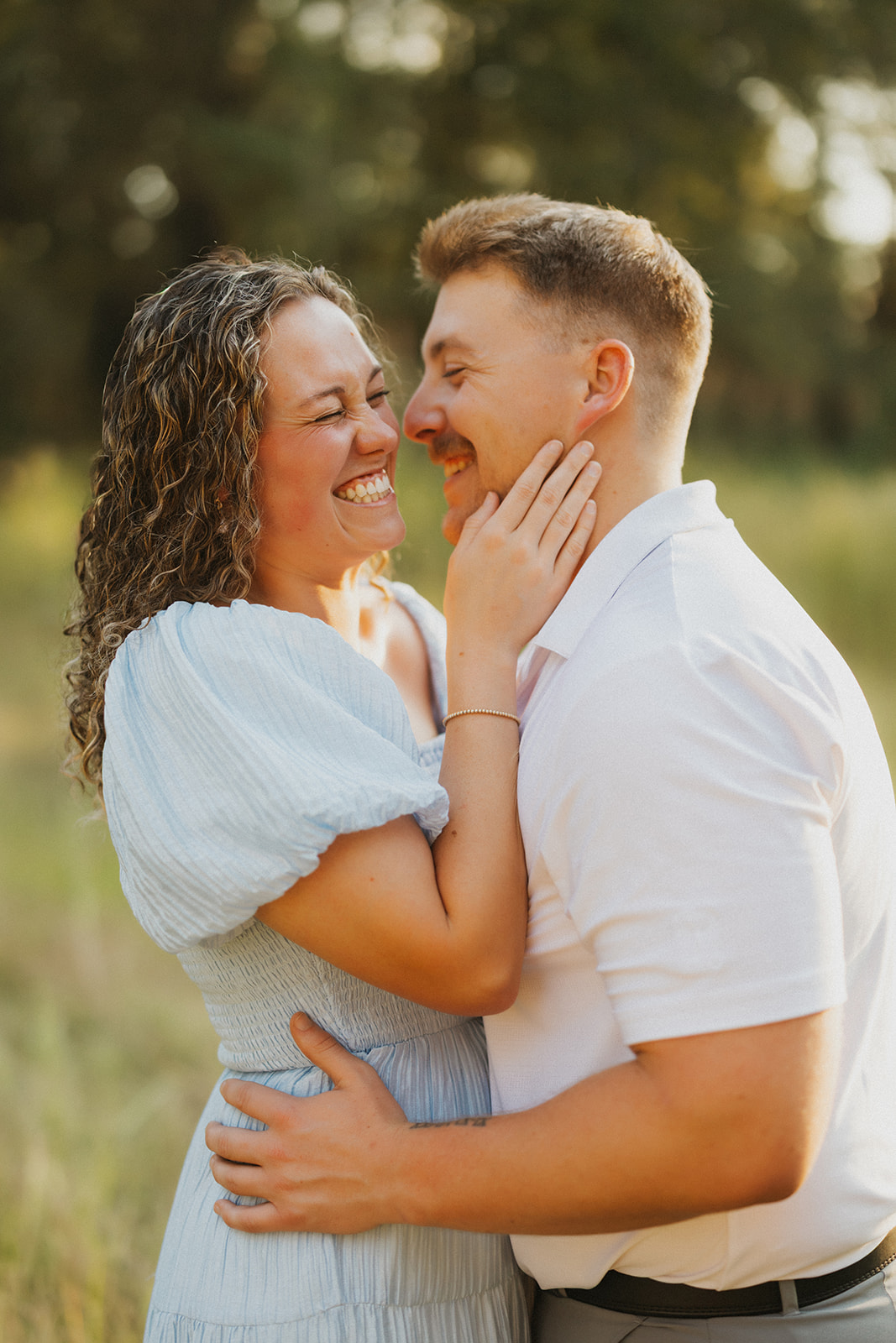 couple laughs while embracing